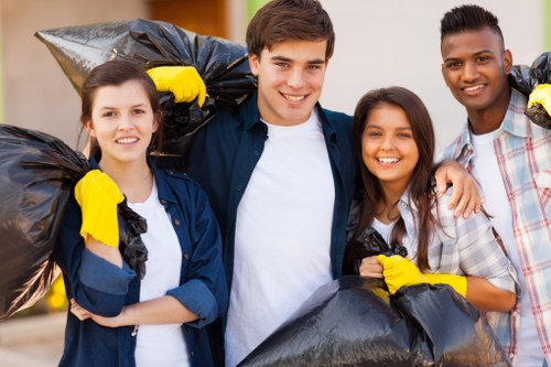 Workers sorting materials at a transfer station and preparing loads for recycling.